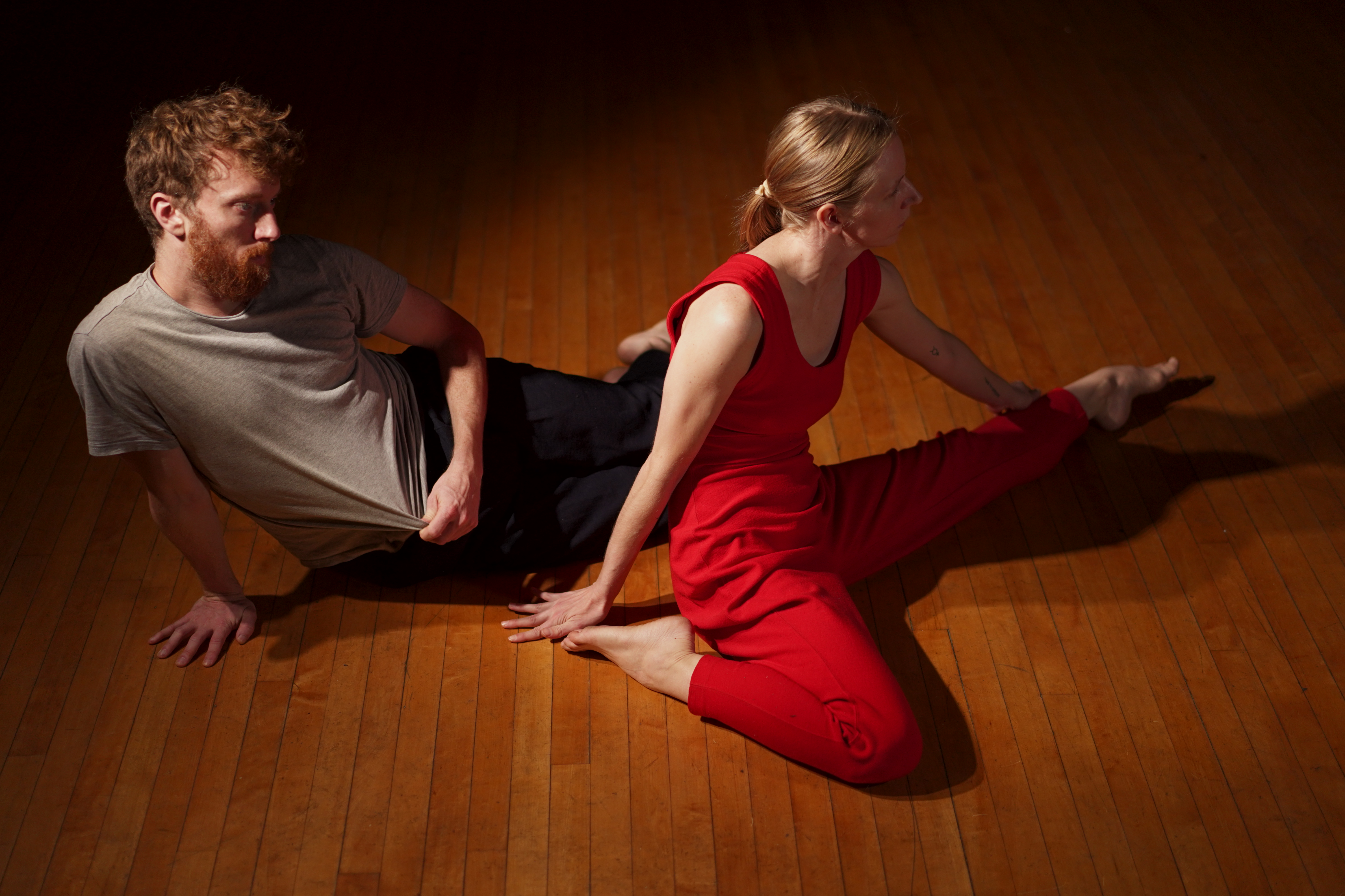 Two dancers sitting on the floor